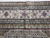 Border detail showing pink arabesques, cream ground, burgundy outlines and layered narrow guard stripes