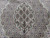 Central scalloped medallion in sage and camel filled with fish lattice and silk highlights