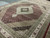 Angled view showing herati fish pattern field, scalloped ivory medallion and black corner spandrels