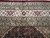 Close-up of multiple guard borders with red palmettes, rosettes and fine silk highlights