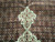 Deep burgundy field covered in herati fish motifs meeting the ivory medallion pendant tip