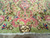 Macro of the signature cartouche and pink vase scrollwork woven near the end border