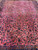 9'9" x 15' Persian Kashan rug viewed lengthwise, symmetrical floral repeat on salmon rose field