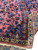 Folded corner revealing the cotton foundation and fine hand-knotted back of this antique rug