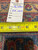 Back of rug with tape measure and inventory tag reading rug number PIX 3559