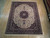 8'1 x 10'1 wool and silk Sino Tabriz rug displayed flat on light wood showroom floor