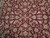 Close-up of palmettes, rosettes and curling leaves woven in ivory, sage green and salmon pink