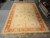 11'1" x 18' oversize Ziegler wool rug laid flat on showroom floor, full pattern visible