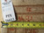 Back tag reading rug number 26613 beside tape measure on tightly hand-knotted wool weave