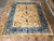 9'3 x 11'2 Chinese Art Deco rug laid flat on tile floor showing full floral design