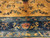 Close-up of teal and navy borders with birds, blossoms and coral rosettes against the gold field