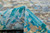 Turquoise and teal pile close-up showing hand-knotted wool loops and mosaic color blocks