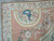 Corner detail showing ivory ribbon border, blue plumed helmet motif and warm salmon field
