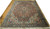 9'8" x 13' Heriz rug displayed on parquet floor showing rust field and navy border
