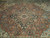 Close-up of navy and ivory central medallion with olive rosettes on rust wool field