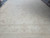 Wide angle showing muted rosette motif and layered border bands of this oversize Oushak rug