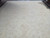 13'7" x 19'2" oversize Oushak rug photographed full length under natural showroom light with tonal border