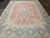Full length photo of the 9'9" x 13'1" Persian Kerman showing its wide ivory main border
