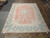 10x13 vintage Persian Kerman rug photographed from above in the Freeport showroom, pink and blue