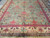 10x20 oversize Indian rug shown lengthwise, green field framed by wide cream palmette border