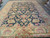 Palace size black and gold wool rug suited to a large living or dining room