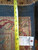 Back of the rug with tape measure and tag confirming hand-knotted construction and size