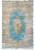 Full overhead view of light blue Persian Kerman rug with ivory floral border and central medallion