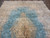 End view showing ivory fringe, blue selvage and the corner spandrel drawing of the Kerman