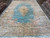 9'10" x 16' Kerman rug seen end to end, ivory border framing the light blue field