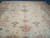 Wide field view of the ivory 18x25 Oushak with symmetrical palmette and rosette layout