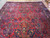 Wide shot of the 11 by 20.6 Sarouk rug corner to corner with fringe visible