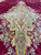 12 x 22 Kerman rug medallion close-up with turquoise arabesques, gold vines and burgundy field