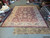 14'3" x 19'6" Chobi rug photographed in the Freeport showroom with inventory tag visible