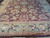 Close view of leafy palmette border and aubergine field with gold and rose accents