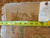 Reverse of the rug with tape measure showing tight hand-knotted wool weave and inventory tag