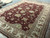Angled view of the 11'8" x 15' Ziegler rug showing corner and guard border stripes