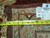 Back of the rug with tag reading 11.8 x 15 and tape measure across weave