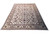 Angled studio view of oversize hand-knotted wool rug with cream field and sage green floral border