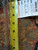 Tape measure on the pile beside warehouse tag reading oriental rug 5725, size 12 x 16