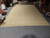 Full length view of sage green and beige Ziegler rug showing symmetrical border bands and fringe