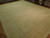 13'6" x 19'2" wool rug shot at an angle, soft tone on tone floral field visible