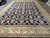 13x19 oversize Persian Mahal rug seen at an angle with navy field and ivory border