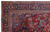 Navy main border with ivory cartouches and rosettes framing the red field of this Persian rug