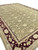 Wide floor view of olive green and burgundy Oriental rug sized for large living rooms