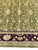 Bright olive field detail with gold, mauve and cream blossoms above the burgundy border