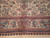 Border close-up showing woven flower vases, rosettes and a small cartouche in the guard band