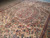 Perspective view of 9x12 ivory Oriental rug showing medallion, spandrels and floral border