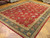 Oversize 12x17 Tabriz rug displayed at an angle in showroom with wood parquet flooring