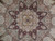 Close-up of star medallion with camel, rose and charcoal floral detail and silk highlights