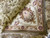 Folded corner detail showing rose palmette, ivory border and hand-tied fringe along the finished edge